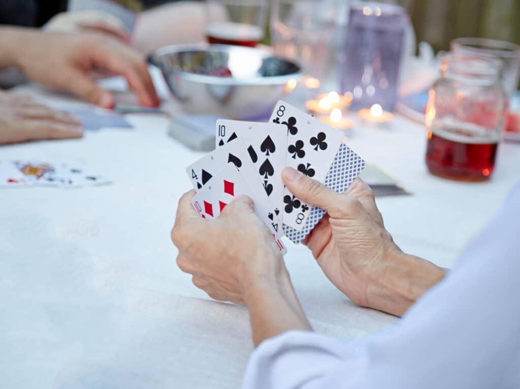 Person playing poker holding four cards